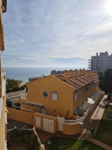 - un bâtiment jaune avec vue sur l'océan dans l'établissement Arenas doradas, à Arenales del Sol