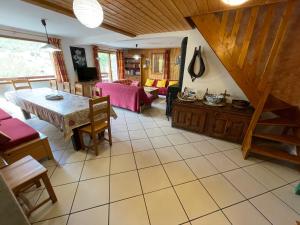 a living room with a table and a couch at Chalets La Caillaude in La Salle-les-Alpes
