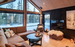 a living room with a couch and a tv at Amazing Home In Lillehammer With 5 Bedrooms, Sauna And Wifi in Lillehammer