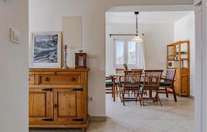 a kitchen and dining room with a table and chairs at Nice Home In Poljica With Wi-fi in Poljica