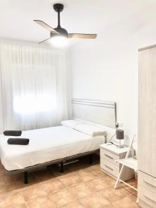 a bedroom with a bed and a ceiling fan at Alhattic in Alhaurín el Grande