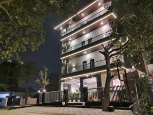a building with lights on it at night at Emerald Suites in Greater Noida