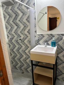 a bathroom with a sink and a mirror at Merak Hostel in Villa de Leyva