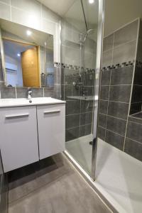 a bathroom with a shower and a sink and a mirror at La Maison de la Plage du Rouet in Carry-le-Rouet