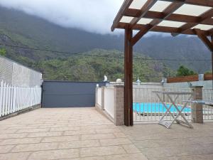 a patio with a view of a mountain at Chez Guy et Josiane in Cilaos