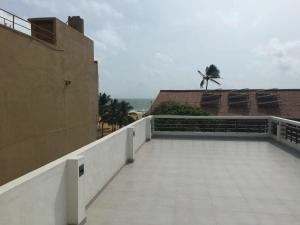 a balcony of a building with a view of the ocean at Splendid Holiday Guest House in Negombo