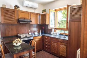 a kitchen with wooden cabinets and a sink at Bilocale con portico a Numana - N175 in Numana