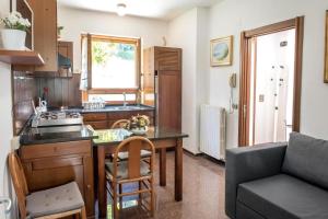 a small kitchen with a table and a couch at Bilocale con portico a Numana - N175 in Numana