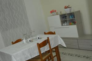 a dining room table with a white table cloth on it at Bed and Breakfast Vecchio Porto in Catania