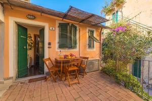 a table and chairs on a patio in front of a house at Il Comandante - Goelba in Porto Azzurro