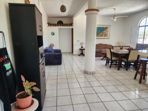 a living room with a kitchen and a dining room at Casa Marina in Puerto Vallarta