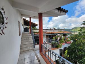 a balcony of a house with a staircase at Casa Marina in Puerto Vallarta