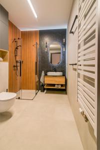 a bathroom with a shower and a sink at MTP/ZOO Prestige Apartments in Poznań