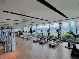 a gym with a bunch of treadmills and machines at Comfy & Cozy Suites 3PX @ Colony, Near Monorail & Quill City Mall in Kuala Lumpur