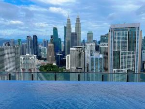 a view of a city skyline from a swimming pool at Comfy & Cozy Suites 3PX @ Colony, Near Monorail & Quill City Mall in Kuala Lumpur
