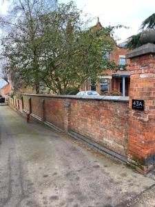 a brick wall with a street sign on it at SPALDING - Self Contained Studio Double - An extra single bed can be provided in Lincolnshire