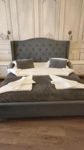 sypialnia z dużym łóżkiem z niebieskim zagłówkiem w obiekcie Luxuroom w Sybinie