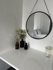 a mirror on top of a white counter in a room at Sunset Cottage in Stockton-on-Tees