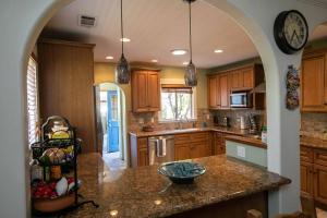 a kitchen with wooden cabinets and a counter top at Long Beach Home Beautiful Private area in Long Beach