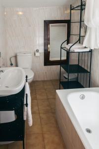 łazienka z umywalką, wanną i toaletą w obiekcie Apartamento Turistico la Solana w mieście Baños de Río Tobía