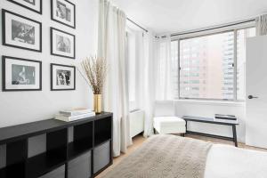a black and white bedroom with a large window at Brooklyn bridge view residence in New York