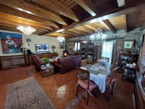 a living room with a table and a couch at Casa La Güelina en Asturias VUT-3276-AS in Arriondas