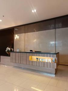 a view of a lobby with a hotel sign on the wall at Grass Residences by Team A in Manila