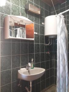 a bathroom with a sink and a mirror at Apartman Ramić in Bihać