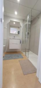 a white bathroom with a sink and a shower at Luxurious modern holiday flat on Mar Menor Golf Resort in Torre-Pacheco