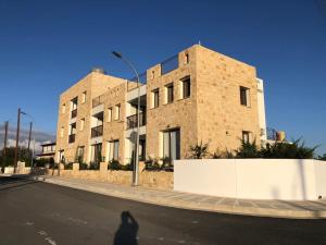 a shadow of a person walking in front of a building at Daniel's Hotel Apartments in Paphos City