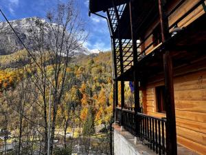a balcony of a cabin with a view of the mountains at Alloggio in antica frazione Walser in Alagna Valsesia