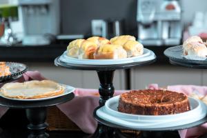 a table topped with plates of pastries and cakes at ibis Presidente Prudente Manoel Goulart in Presidente Prudente