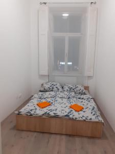 a small bed in a room with a window at Fantomas*** N4 City Center Apartments 3 Bedroom + Living room in Szombathely
