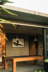 a wooden bench sitting in front of a wall at Wave House - Surf Camp in Canggu