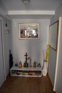 a room with a shelf with various items on it at Cleopatra in Buenos Aires