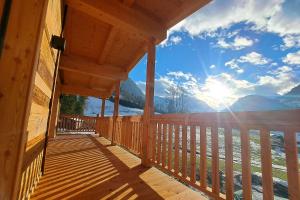 a porch of a cabin with a view of the mountains at Chalet - Das Schrofen in Ramsau im Zillertal
