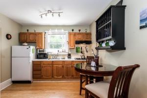 a kitchen with wooden cabinets and a white refrigerator at Cozy Apartment in Downtown Neighborhood in Columbia