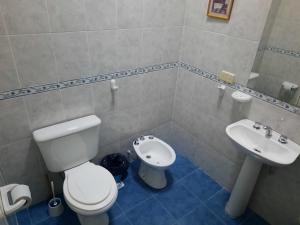 y baño con aseo y lavamanos. en Cabaña El Hornero en Mina Clavero