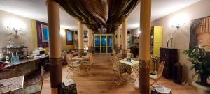 a living room with tables and chairs in a building at B&B Abracadabra in Ravenna
