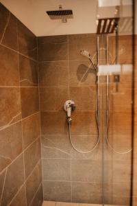 a shower with a shower head in a bathroom at Wohnung Finstermünz in Lenggries