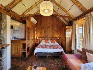 a bedroom with a bed in a wooden room at Apart Hotel Del Arroyo in San Carlos de Bariloche