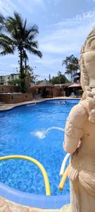 a large blue swimming pool with aitatingitatingitatingitating at Hotel Pousada dos Condes in Maresias