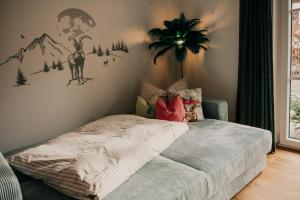 a bedroom with a bed with a monkey on the wall at Wohnung Finstermünz in Lenggries