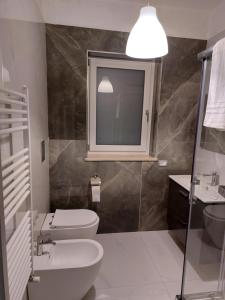 a bathroom with a sink and a toilet and a mirror at Tenuta Casa Arsa in Montemarano