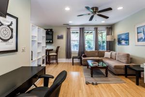 a living room with a couch and a ceiling fan at Cozy Apartment in Downtown Neighborhood in Columbia