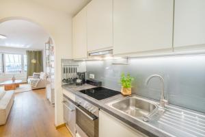 a kitchen with a sink and a stove at Design-Studio "Fellhorn" im modernen Skandi-Stil in Oberstdorf +15 photos