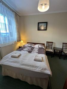 Posteľ alebo postele v izbe v ubytovaní Apartamenty Złota Palma