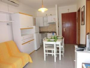 a small kitchen with a small table in a room at Functional 1 bedroom apartment with shared pool in Bibione