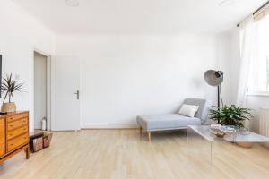 a living room with a couch and a table at Loft-style apartment with large roof terrace in London