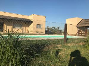 a shadow of a person standing in front of a fence at Casa de campo “Doña Elisa” in San Andrés de Giles